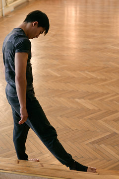 Barefoot dancer before workout in studio