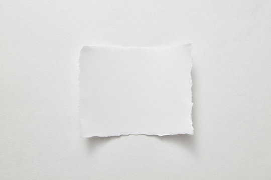 Empty sheet of paper presented on a gray paper background with copy space for text. Layout for your ideas. Top view