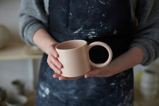 Pottery artisan with craft mug
