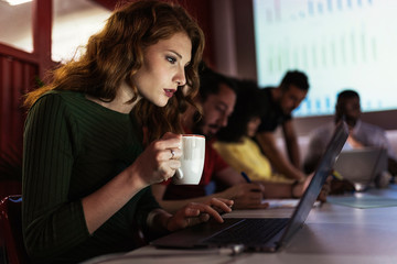 Concentrated businesswoman working in creative office