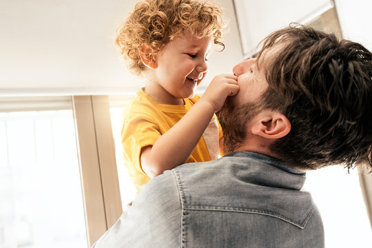 Proud father and his son playing