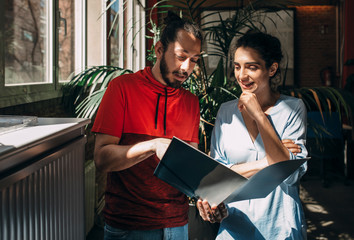 Casual business couple checking documents in the office