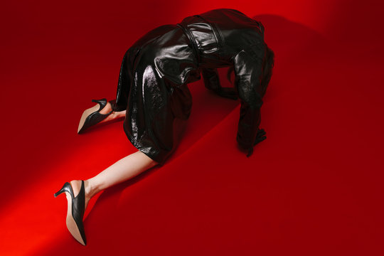 model with fake leather jacket on red background