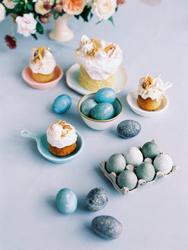 Easter eggs and pastry on a blue background