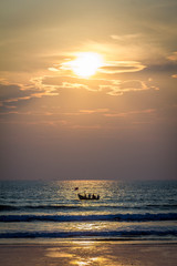 A boat with Indian fishermen during sunset in Arambol