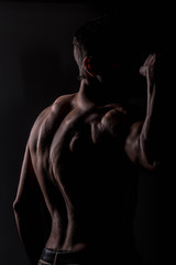 Fototapeta na wymiar Strong athletic man on black background, Fitness shaped muscle man posing 