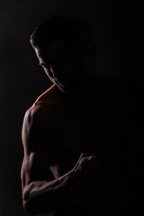 Strong athletic man on black background, Fitness shaped muscle man posing 