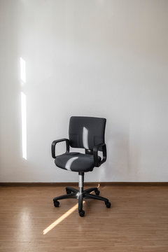 Lone desk chair in an empty room