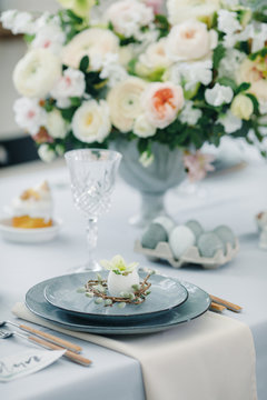 Kitchen and beautiful table set in room. Beautiful table setting for Easter
