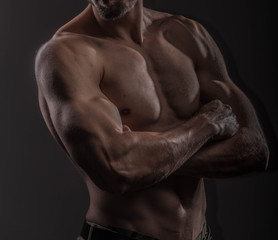 Fototapeta na wymiar Strong athletic man on black background, Fitness shaped muscle man posing 