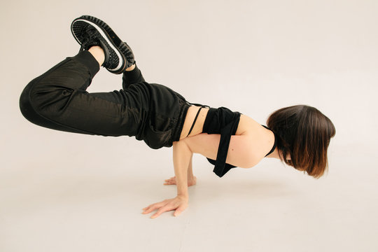 Anonymous female performing breakdance movement