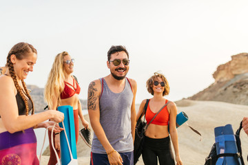 Group of people doing yoga at the cliff