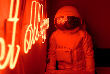 Anonymous astronaut sitting in cafe