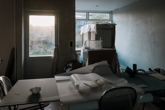 Rebuilding site with papers, masks and boxes in the evening light