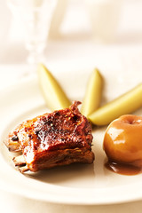Fried pork ribs with potato dumplings. Bright background. 