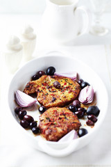 Roast Pork Steaks with olives. Bright background. 