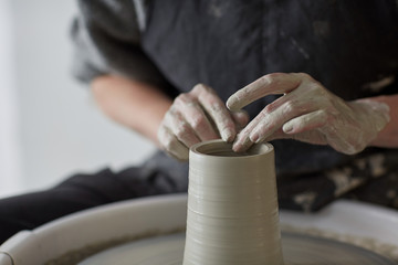 Female hands at work with the potter wheel