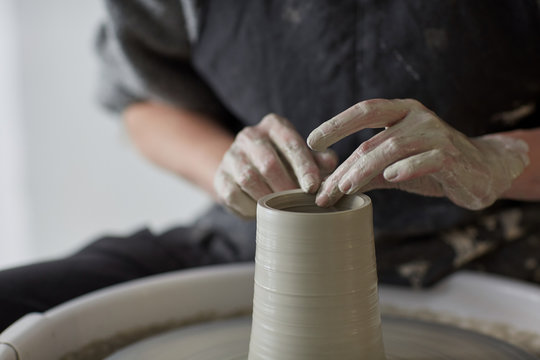 Female hands at work with the potter wheel