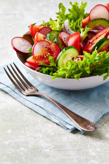 Healthy Salad with Cherry Tomatoes, Green Olives, Radish, Leek, Lettuce and Fresh Basil. Easy summer snack. Close up.