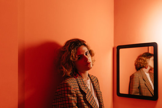Woman standing in front of mirror