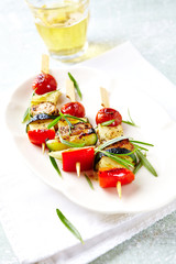 Shish Kebabs on bright wooden background.