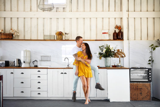 couple hugging in kitchen