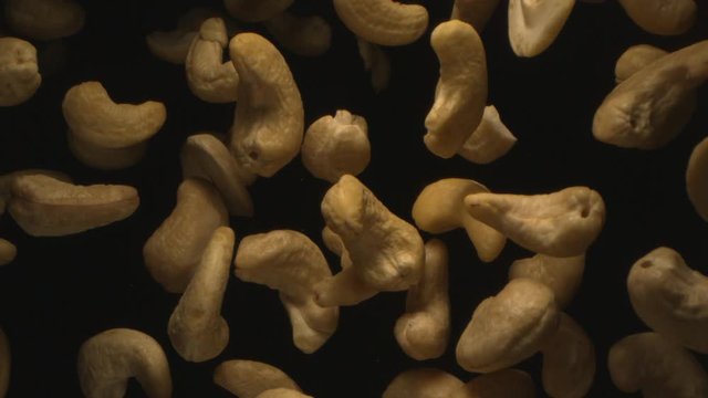 Cashew Nuts Flying in the Air in a Free Fall in Slow Motion on Black Background at 1500 fps