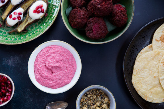 Middle eastern Mezze including aubergine boats, beetroot hummus and beetroot falafel.