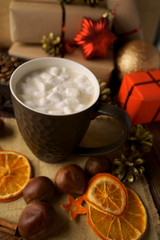 Christmas morning and coffee with marshmallows, chestnuts and gifts. Vertical frame.