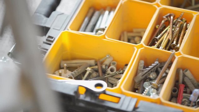 Screws, bolts and nails in a containment box