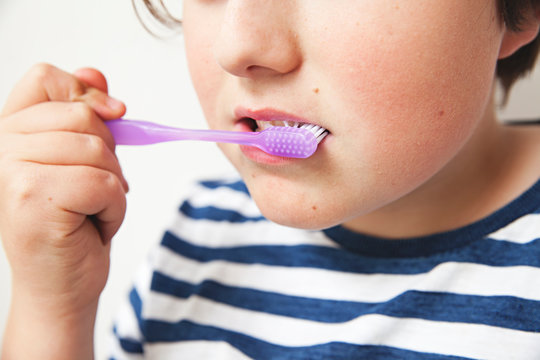 Close up of boy brushing his teeth