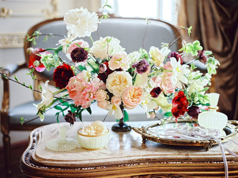 Flower composition on table in classic interior