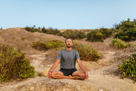 Meditation on a rock at the beach