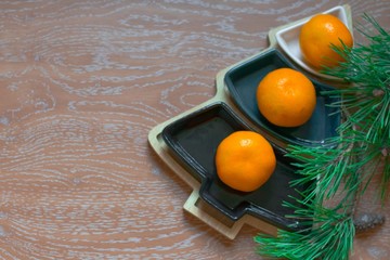 tangerines, Christmas tree on a wooden background. plans for New year and Christmas.