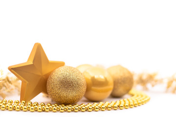 Gold Christmas ornaments isolated on a white, minimalist background with copy space