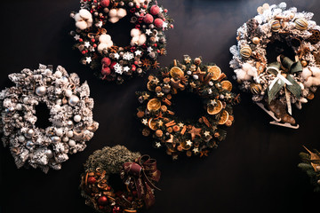 Creative Christmas wreath. An unusual idea for a holiday home decor  girl holds a Christmas tree handmade, blurred background. very beautiful