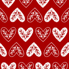 Seamless pattern of hearts with ethnic branch.
