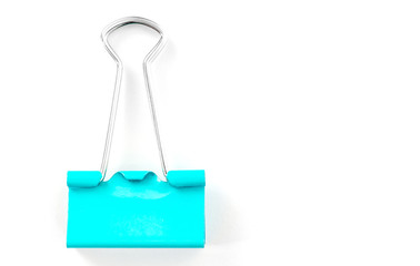 Single blue binder clip isolated on white background. Clerical clip for paper with copy space for text