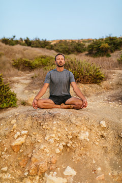 Meditation on a rock at the beach