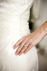 Bride showing dress and ring