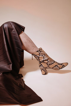 Man in stylish boots and skirt