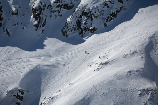 Snowboarder skiing outside the track