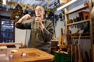 craftsman making a guitar in his woodwork workshop