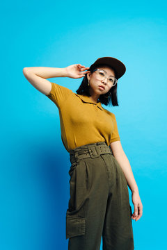 Young serious stylish lady in cap