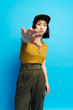 Young serious stylish lady in cap