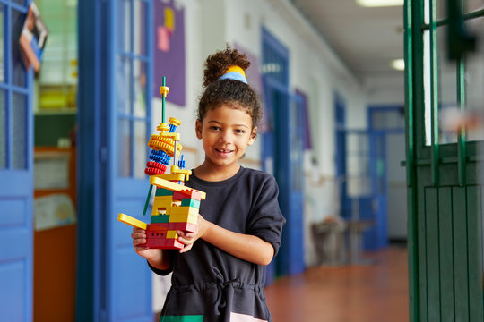 Schoolgirl playing with blocks