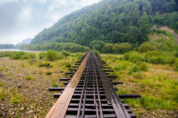 Old wooden railway bridge with footpath