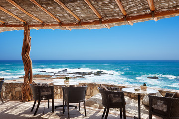 Outdoor restaurant patio on the ocean at a luxury resort in Mexico