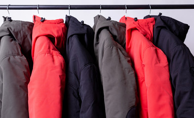 family concept or showroom of down jacket winter parka hanging on a hanger in the wardrobe © oleg_ermak