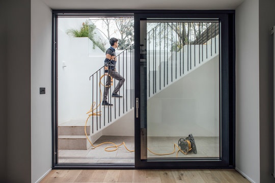 Fototapeta Man Holding Yellow Hose